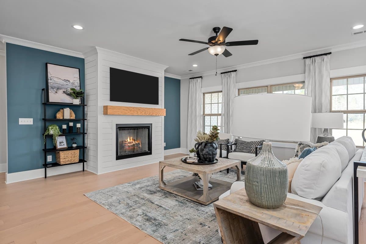Davidson Homes living room with a shiplap fireplace and open connection to the kitchen